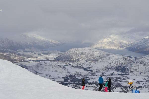 Skiers at Coronet Peak with Lake Wakatipu (L) and Lake Johnson (R)